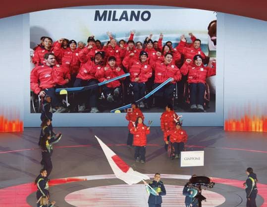 Milan Cortina Paralympics: Opening ceremony Japan s delegation, represented by para Ice hockey, Eishockey players Shunsuke Nakamura and Akari Fukunishi, marches during the opening ceremony of the Milan Cortina Paralympics at the Verona Arena, a Roman amphitheater in Verona, Italy, on March 6, 2026, while other members of the team are shown taking part in a pre-recorded message on a large screen in the back.  A14AA0005355738P