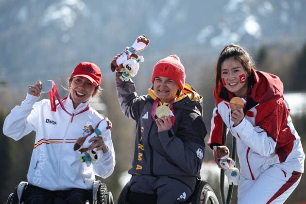 ITALY, VENETO - MARCH 7, 2026: Silver medallist Audrey Pascual Seco of Spain, gold medal winner Anna-Lena Forster and bronze medallist Sitong Liu of China (L-R) celebrate during the victory ceremony for the women s para alpine skiing downhill sit-skiing event at the 2026 Winter Paralympic Games on the Olympia delle Tofane of the Tofane Alpine Skiing Centre in Cortina d Ampezzo, Province of Belluno 2026 Winter Paralympics: Para-Alpine Skiing  - ZUMAt113 20260307_zaa_t113_559 Copyright: xMikhailxTereshchenkox