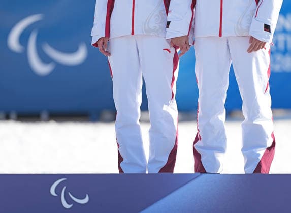 (260308) -- TESERO, March 8, 2026 -- Gold medalist Wang Yue (L) and her guide Chen Guoming of China react on the podium after the women s sprint vision impaired final of para biathon at the Milan-Cortina 2026 Paralympic Winter games, Winterspiele,Spiele, Summer games in Tesero, Italy, March 7, 2026. ) (SP)ITALY-TESERO-PARALYMPIC WINTER GAMES-PARA BIATHLON-WOMEN S SPRINT VISION IMPAIRED HouxZhaokang 