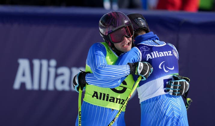 (260308) -- CORTINA D AMPEZZO, March 8, 2026 -- Giacomo Bertagnolli (R) of Italy hugs his guide Andrea Ravelli during the para alpine skiing men s downhill vision impaired match at the Milan-Cortina 2026 Paralympic Winter games, Winterspiele,Spiele, Summer games in Cortina D ampezzo, Italy, March 7, 2026. ) (SP)ITALY-CORTINA D AMPEZZO-PARALYMPIC WINTER GAMES-PARA ALPINE SKIING-MEN S DOWNHILL-VISION IMPAIRED WangxKaiyan 