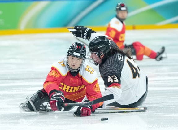 (260308) -- MILAN, March 8, 2026 -- China s Shen Yifeng (L) vies with Germany s Bernhard Hering during the Para Ice hockey, Eishockey preliminary round Group A match between China and Germany at the Milan-Cortina 2026 Paralympic Winter games, Winterspiele,Spiele, Summer games in Milan, Italy, March 7, 2026. ) (SP)ITALY-MILAN-PARALYMPIC WINTER GAMES-PARA ICE HOCKEY-CHINA VS GERMANY LixJing 