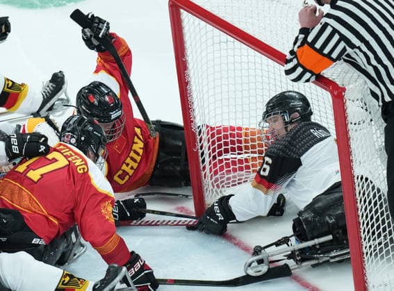(260308) -- MILAN, March 8, 2026 -- China s Shen Yifeng (L) and Chen Hongyu (C) vie with Germany s Hugo Raedler during the Para Ice hockey, Eishockey preliminary round Group A match between China and Germany at the Milan-Cortina 2026 Paralympic Winter games, Winterspiele,Spiele, Summer games in Milan, Italy, March 7, 2026. ) (SP)ITALY-MILAN-PARALYMPIC WINTER GAMES-PARA ICE HOCKEY-CHINA VS GERMANY LixJing 