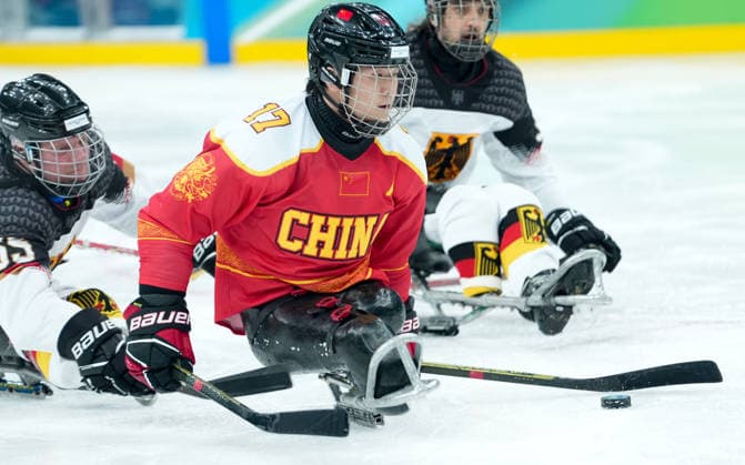 (260308) -- MILAN, March 8, 2026 -- China s Shen Yifeng shoots during the Para Ice hockey, Eishockey preliminary round Group A match between China and Germany at the Milan-Cortina 2026 Paralympic Winter games, Winterspiele,Spiele, Summer games in Milan, Italy, March 7, 2026. ) (SP)ITALY-MILAN-PARALYMPIC WINTER GAMES-PARA ICE HOCKEY-CHINA VS GERMANY LixJing 