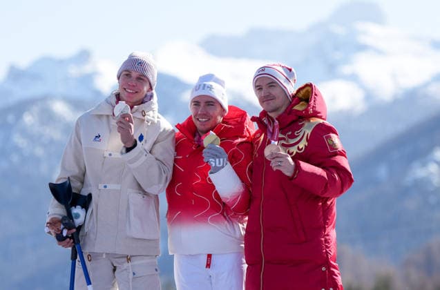 (260308) -- CORTINA D AMPEZZO, March 8, 2026 -- Gold medalist Robin Cuche (C) of Switzerland, silver medalist Arthur Bauchet (L) of France, bronze medalist Aleksei Bugaev of Russia react during the awarding ceremony for the para alpine skiing men s downhill standing match at the Milan-Cortina 2026 Paralympic Winter games, Winterspiele,Spiele, Summer games in Cortina D ampezzo, Italy, March 7, 2026. ) (SP)ITALY-CORTINA D AMPEZZO-PARALYMPIC WINTER GAMES-PARA ALPINE SKIING-MEN S DOWNHILL-STANDING WangxKaiyan 