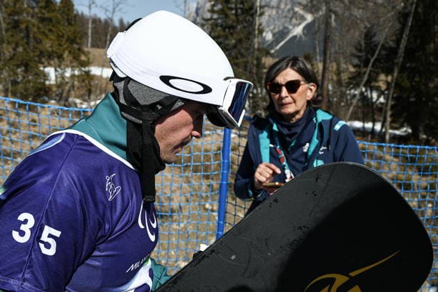 ITALY, VENETO - MARCH 8, 2026: Dmitry Fadeyev of Russia competes during the men s para snowboard snowboard cross SB-LL1 event at Cortina Para Snowboard Park during the 2026 Winter Paralympic Games. Mikhail Tereshchenko TASS  89753581