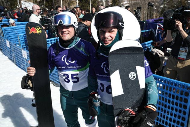 ITALY, VENETO - MARCH 8, 2026: Dmitry Fadeyev (L) and Filipp Shebbo of Russia during the men s para snowboard snowboard cross SB-LL1 event at Cortina Para Snowboard Park during the 2026 Winter Paralympic Games. Mikhail Tereshchenko TASS  89753676
