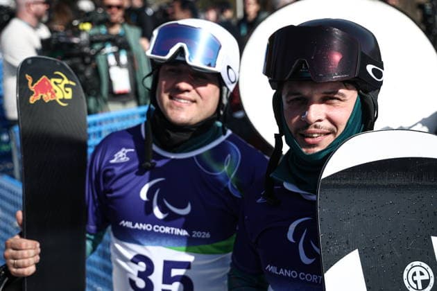 ITALY, VENETO - MARCH 8, 2026: Dmitry Fadeyev (L) and Filipp Shebbo of Russia during the men s para snowboard snowboard cross SB-LL1 event at Cortina Para Snowboard Park during the 2026 Winter Paralympic Games. Mikhail Tereshchenko TASS  89753677