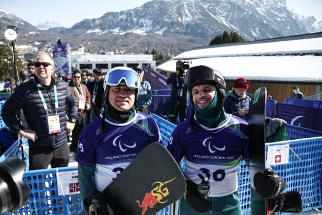 ITALY, VENETO - MARCH 8, 2026: Dmitry Fadeyev (L) and Filipp Shebbo of Russia during the men s para snowboard snowboard cross SB-LL1 event at Cortina Para Snowboard Park during the 2026 Winter Paralympic Games. Mikhail Tereshchenko TASS  89753678