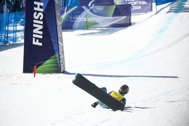 ITALY, VENETO - MARCH 8, 2026: Filipp Shebbo of Russia loses balance during the men s para snowboard snowboard cross SB-LL1 event at Cortina Para Snowboard Park during the 2026 Winter Paralympic Games. Mikhail Tereshchenko TASS  89754078
