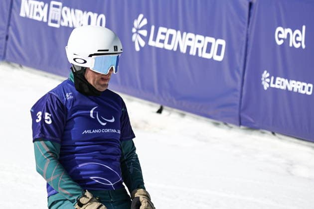 ITALY, VENETO - MARCH 8, 2026: Dmitry Fadeyev of Russia during the men s para snowboard snowboard cross SB-LL1 event at Cortina Para Snowboard Park during the 2026 Winter Paralympic Games. Mikhail Tereshchenko TASS  89754192