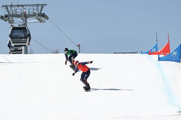 ITALY, VENETO - MARCH 8, 2026: Mike Schultz (front) and Noah Elliott of the US compete during the men s para snowboard snowboard cross SB-LL1 event at Cortina Para Snowboard Park during the 2026 Winter Paralympic Games 2026 Winter Paralympics: Para Snowboard  - ZUMAt113 20260308_zaa_t113_113 Copyright: xMikhailxTereshchenkox