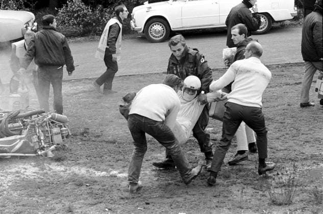 Medical experts manhandle the unfortunate Brian Redman (GBR) from his wrecked Cooper T86B. He suffered a badly broken arm that saw him out of F1 for two seasons. ..Belgian Grand Prix, Spa-Francorchamps, June 9 1968. Copyright: xSuttonxMotorsportsx