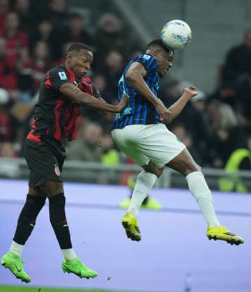 (260309) -- MILAN, March 9, 2026 -- AC Milan s Pervis Estupinan (L) vies with Inter Milan s Denzel Dumfries during an Italian Serie A football match between AC Milan and Inter Milan in Milan, Italy, March 8, 2026. ) (SP)ITALY-MILAN-FOOTBALL-SERIE A-AC MILAN VS INTER MILAN LixJing 