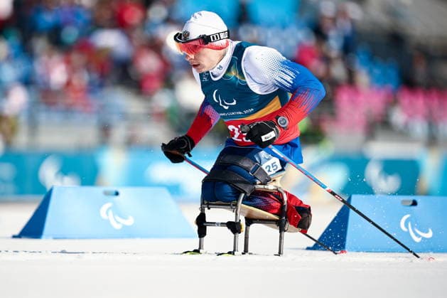 ITALY, TESERO - MARCH 10, 2026: Ivan Golubkov of Russia competes in a men s para cross-country skiing sitting sprint at Tesero Cross-Country Stadium during the 2026 Winter Paralympic Games. Mikhail Tereshchenko TASS  89841976