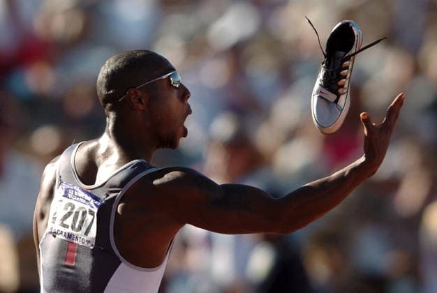 Bernard Williams juggled his shoes before tossing them into the crowd Sunday July 18, 2004 at the U.S. Olympic Track and Field Trials at Alex G. Spanos Sports Complex in Sacramento, Calif. Bernard Williams (r) took 3rd in the 200m dash and qualified for the trip to Athens. (Contra Costa Times Karl Mondon) SACRAMENTO California USA Copyright: xKarlxMondonx