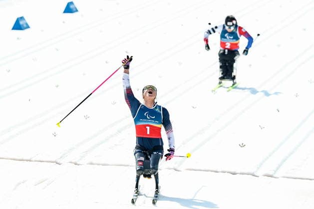 ITALY, TESERO - MARCH 10, 2026: Oksana Masters (L) of the USA and Yunji Kim of South Korea finish a women s para cross-country skiing sitting sprint final at Tesero Cross-Country Stadium during the 2026 Winter Paralympic Games. Mikhail Tereshchenko TASS  89847104