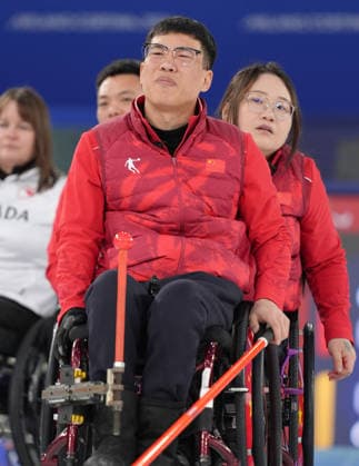 (260310) -- CORTINA D AMPEZZO, March 10, 2026 -- Chen Jianxin (front) of China reacts during the wheelchair curling mixed team round robin session 7 match between China and Canada at the Milan-Cortina 2026 Paralympic Winter games, Winterspiele,Spiele, Summer games in Cortina D ampezzo, Italy, March 10, 2026. ) (SP)ITALY-CORTINA D AMPEZZO-PARALYMPIC WINTER GAMES-WHEELCHAIR CURLING-MIXED TEAM-ROUND ROBIN-CHN VS CAN CaixYang 