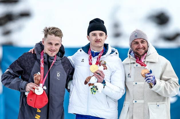 ITALY, TESERO - MARCH 10, 2026: Silver medalist Sebastian Marburger of Germany, gold medalist Raman Svirydzenka of Belarus, and Benjamin Daviet (L-R) of France poses during the victory ceremony for the men s para cross-country skiing classic standing sprint event at Tesero Cross-Country Stadium during the 2026 Winter Paralympic Games 2026 Winter Paralympics: Para Cross-Country Skiing  - ZUMAt113 20260310_zaa_t113_275 Copyright: xMikhailxTereshchenkox