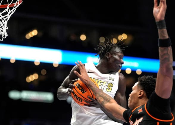 MAR 10 2026: Colorado Buffaloes forward Bangot Dak (8) brings down the rebound against Oklahoma State Cowboys forward Christian Coleman (4) in the Big 12 Championship Tournament at T-Mobile center, Kansas City, Missouri. CSM. Kansas City United States - ZUMAc04_ 20260310_zma_c04_200 Copyright: xJonxRobichaudx