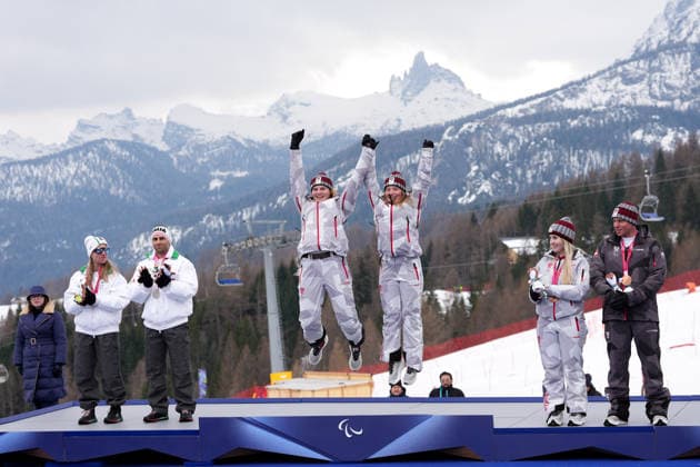 (260311) -- CORTINA D AMPEZZO, March 11, 2026 -- Gold medalist Veronika Aigner (3rd L) and her guide Lilly Sammer (3rd R) of Austria, silver medalist Chiara Mazzel (1st L) of Italy and her guide Nicola Cotti Cottini (2nd L) and bronze medalist Elina Stary (2nd R) and her guide Stefan Winter (1st R) of Austria attend the awarding ceremony for the para alpine skiing women s combined vision impaired event at the Milan-Cortina 2026 Paralympic Winter games, Winterspiele,Spiele, Summer games in Cortina D ampezzo, Italy, March 10, 2026. ) (SP)ITALY-CORTINA D AMPEZZO-PARALYMPIC WINTER GAMES-PARA ALPINE SKIING-WOMEN S COMBINED-VISION IMPAIRED LianxYi 