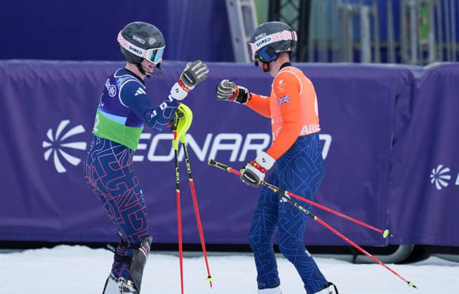 (260311) -- CORTINA D AMPEZZO, March 11, 2026 -- Neil Simpson (L) and his guide Rob Poth of Britain celebrate after the Para Alpine Skiing Men s Alpine Combined Vision Impaired event at the Milan-Cortina 2026 Paralympic Winter games, Winterspiele,Spiele, Summer games in Cortina D ampezzo, Italy, March 10, 2026. ) (SP)ITALY-CORTINA D AMPEZZO-PARALYMPIC WINTER GAMES-PARA ALPINE SKIING-MEN S ALPINE COMBINED-VISION IMPAIRED WangxKaiyan 