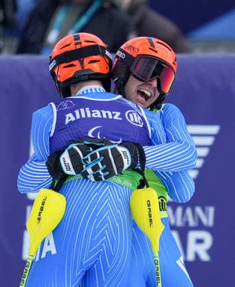 (260311) -- CORTINA D AMPEZZO, March 11, 2026 -- Giacomo Bertagnolli (L) and his guide Andrea Ravelli of Italy celebrate after winning the Para Alpine Skiing Men s Alpine Combined Vision Impaired event at the Milan-Cortina 2026 Paralympic Winter games, Winterspiele,Spiele, Summer games in Cortina D ampezzo, Italy, March 10, 2026. ) (SP)ITALY-CORTINA D AMPEZZO-PARALYMPIC WINTER GAMES-PARA ALPINE SKIING-MEN S ALPINE COMBINED-VISION IMPAIRED WangxKaiyan 