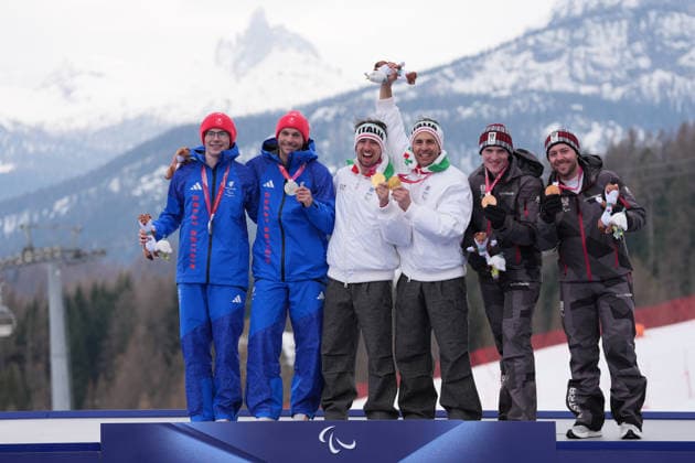 (260311) -- CORTINA D AMPEZZO, March 11, 2026 -- Gold medalist Giacomo Bertagnolli (3rd L) and his guide Andrea Ravelli (3rd R) of Italy, silver medalist Neil Simpson (1st L) and his guide Rob Poth (2nd L) of Britain and bronze medalist Johannes Aigner (2nd R) and his guide Nico Haberl of Austria attend the awarding ceremony for the Para Alpine Skiing Men s Alpine Combined Vision Impaired event at the Milan-Cortina 2026 Paralympic Winter games, Winterspiele,Spiele, Summer games in Cortina D ampezzo, Italy, March 10, 2026. ) (SP)ITALY-CORTINA D AMPEZZO-PARALYMPIC WINTER GAMES-PARA ALPINE SKIING-MEN S ALPINE COMBINED-VISION IMPAIRED LianxYi 