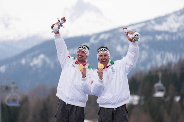 (260311) -- CORTINA D AMPEZZO, March 11, 2026 -- Gold medalist Giacomo Bertagnolli (L) and his guide Andrea Ravelli of Italy celebrate during the awarding ceremony for the Para Alpine Skiing Men s Alpine Combined Vision Impaired event at the Milan-Cortina 2026 Paralympic Winter games, Winterspiele,Spiele, Summer games in Cortina D ampezzo, Italy, March 10, 2026. ) (SP)ITALY-CORTINA D AMPEZZO-PARALYMPIC WINTER GAMES-PARA ALPINE SKIING-MEN S ALPINE COMBINED-VISION IMPAIRED LianxYi 