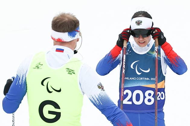 ITALY, TESERO - MARCH 11, 2026: Guide Sergei Siniakin and Anastasia Bagiian of Russia compete in the women s para cross-country skiing 10km interval start classic vision impaired final at Tesero Cross-Country Stadium during the 2026 Winter Paralympic Games 2026 Winter Paralympics: Para Cross-Country Skiing  - ZUMAt113 20260311_zaa_t113_193 Copyright: xMikhailxTereshchenkox
