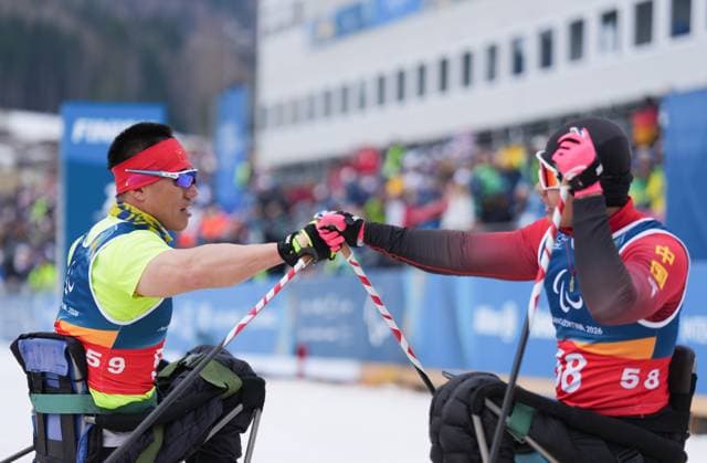 (260311) -- TESERO, March 11, 2026 -- Mao Zhongwu (L) and Zheng Peng of China greet each other after the final match of the men s 10km interval start sitting of Para Cross-Country Skiing at the Milan-Cortina 2026 Paralympic Winter games, Winterspiele,Spiele, Summer games in Tesero, Italy, March 11, 2026. ) (SP)ITALY-TESERO-PARALYMPIC WINTER GAMES-PARA CROSS-COUNTRY-MEN S 10KM INTERVAL START SITTING LianxZhen 