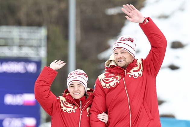 ITALY, TESERO - MARCH 11, 2026: Gold medalists Anastasia Bagiian and guide Sergei Siniakin of Russia pose at a victory ceremony for the women s para cross-country skiing 10km interval start classic vision impaired at Tesero Cross-Country Stadium during the 2026 Winter Paralympic Games. Mikhail Tereshchenko TASS  89886952