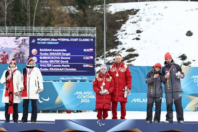 ITALY, TESERO - MARCH 11, 2026: Silver medalists Simona Bubenickova and guide David Srutek of the Czech Republic, gold medalists Anastasia Bagiian and guide Sergei Siniakin of Russia, and bronze medalists Leonie Maria Walter and guide Christian Krasman (L-R) of Germany pose at a victory ceremony for the women s para cross-country skiing 10km interval start classic vision impaired at Tesero Cross-Country Stadium during the 2026 Winter Paralympic Games 2026 Winter Paralympics: Para Cross-Country Skiing  - ZUMAt113 20260311_zaa_t113_264 Copyright: xMikhailxTereshchenkox
