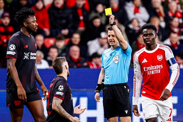 Referee Umut Meler shows a yellow card to Robert Andrich of Bayer 04 Leverkusen Bayer 04 Leverkusen v Arsenal FC, UEFA Champions League 2025 26 Round of 16 First Leg, Bayer 04 Leverkusen v Arsenal FC, BayArena, March 11, 2026, Leverkusen, Germany.