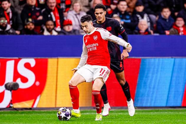 Gabriel Martinelli of Arsenal FC battles for possession with Jarell Quansah of Bayer 04 Leverkusen Bayer 04 Leverkusen v Arsenal FC, UEFA Champions League 2025 26 Round of 16 First Leg, Bayer 04 Leverkusen v Arsenal FC, BayArena, March 11, 2026, Leverkusen, Germany.