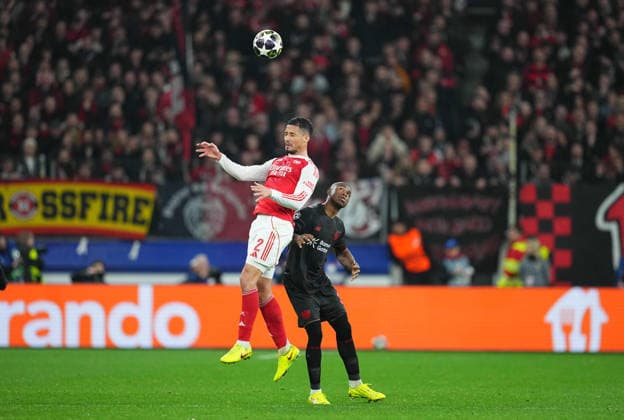 William Saliba (FC Arsenal) and Christian Kofane (Bayer 04 Leverkusen) battle for the ball during Bayer Leverkusen and FC Arsenal at BayArena, Leverkusen, Germany on March 11, 2026. Thor Wegner DeFodi Images. (Photo by DeFodi Images) -