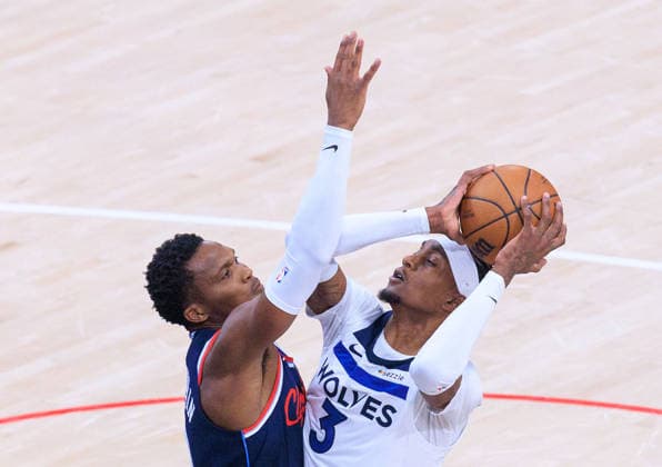 March 11, 2026, Inglewood, California, USA: Jaden McDaniels 3 of the Minnesota Timberwolves puts a shot over Bennedict Mathurin 9 of the LA Clippers during a 2026 NBA, Basketball Herren, USA regular season game on Wednesday March 11, 2026 at Intuit Dome Arena in Inglewood, California. JAVIER ROJAS PI Inglewood USA - ZUMAp124 20260311_zaa_p124_051 Copyright: xJavierxRojasx