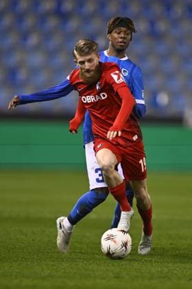 Freiburg s Niklas Beste and Genk s Noah Adedeji-Sternberg fight for the ball during a game between Belgian soccer team KRC Genk and German Freiburg, Thursday 12 March 2026 in Genk, the first leg of the 1 16 Finals of the UEFA Europa League tournament. JOHAN EYCKENS JohanxEyckens  x167297494x