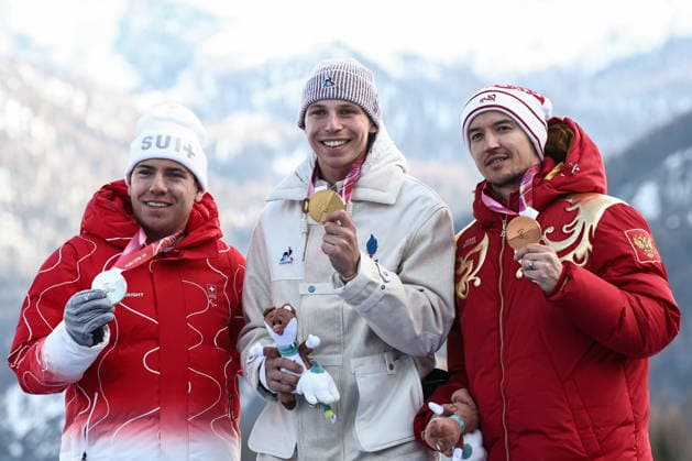 ITALY, VENETO - MARCH 13, 2026: Silver medallist Robin Cuche of Switzerland, gold medal winner Arthur Bauchet of France and bronze medallist Aleksei Bugaev of Russia (L-R) during the victory ceremony for the men s para alpine skiing giant slalom standing event at Tofane Alpine Skiing Centre during the 2026 Winter Paralympic Games, in Cortina d Ampezzo, Province of Belluno 2026 Winter Paralympics: Para Alpine Skiing  - ZUMAt113 20260313_zaa_t113_276 Copyright: xMikhailxTereshchenkox