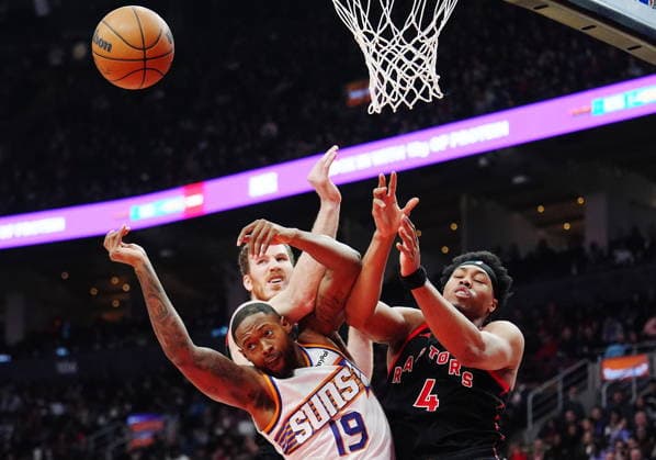 March 13, 2026, Toronto, On, Canada: Phoenix Suns Haywood Highsmith (19) battles for a rebound with Toronto Raptors Scottie Barnes (4) and Jakob Poeltl (centre) during first half NBA, Basketball Herren, USA basketball action in Toronto on Friday, March 13, 2026. Canada News - March 13, 2026  - ZUMAc35_ 20260313_zaf_c35_124 Copyright: xFrankxGunnx