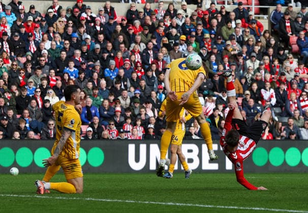 Sunderland, England, 14th March 2026. Chris Rigg (R) of Sunderland shoots at goal during the Sunderland vs Brighton and Hove Albion Premier League match at the Stadium Of Light, Sunderland. Picture credit should read: Nigel Roddis Sportimage EDITORIAL USE ONLY. No use with unauthorised audio, video, data, fixture lists, club league logos or live services. Online in-match use limited to 120 images, no video emulation. No use in betting, games or single club league player publications. SPI_013_NR_SUND_BRIG SPI-4601-0013