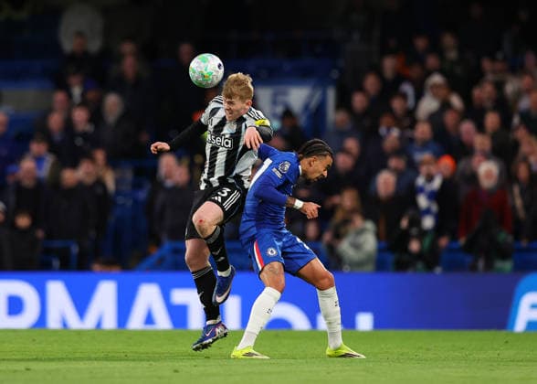 14th March 2026; Stamford Bridge, Chelsea, London, England: Premier League Football, Chelsea versus Newcastle United; Lewis Hall of Newcastle United heads the ball over Malo Gusto of Chelsea  JPxFletcher Content restricted for UK based newspaper