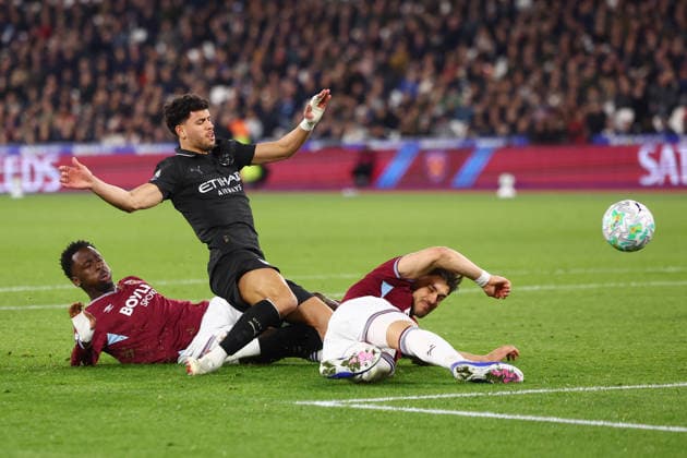 London, England, 14th March 2026. Matheus Nunes of Manchester City is challenged by Soungoutou Magassa (L) and Konstantinos Mavropanos of West Ham United during the West Ham United vs Manchester City Premier League match at the London Stadium, London. Picture credit should read: Paul Terry Sportimage EDITORIAL USE ONLY. No use with unauthorised audio, video, data, fixture lists, club league logos or live services. Online in-match use limited to 120 images, no video emulation. No use in betting, games or single club league player publications. SPI_039_PT_West_Ham_Man_City SPI-4602-0040