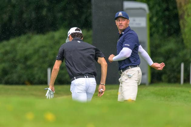 March 15, 2026, Singapore, Ingapore, Singapore: Leader, Joaquin Niemann from Chile, and Bryson DeChambeau from the USA, run for cover as rain stops play..Final Round of the LIV Golf in Singapore Final Round Of The LIV Golf In Singapore  - ZUMAr144 20260315_zap_r144_001 Copyright: xJaynexRussellx