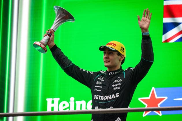 Formula 1 Chinese Grand Prix 2026 SHANGHAI, CHINA - MARCH 15: Second placed George Russell of Great Britain and Mercedes AMG Petronas F1 Team lifts his trophy on the podium during the F1 Grand Prix of China at Shanghai International Circuit on March 15, 2026 in Shanghai, China. John Ricky Anadolu Shanghai China. Editorial use only. Please get in touch for any other usage.  Copyright: x2026xAnadoluxJohnxRickyx