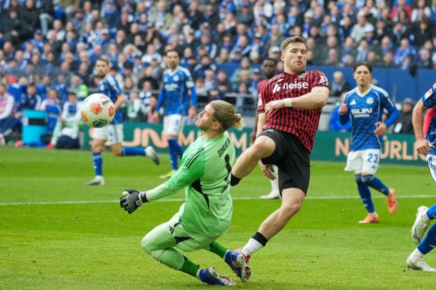 Fussball: 2. Bundesliga, 26. Spieltag, FC Schalke 04 - Hannover 96 am 15.03.2026 in Gelsenkirchen (VELTINS-Arena), Deutschland, Saison 2025 2026: DFB DFL REGULATIONS PROHIBIT ANY USE OF PHOTOGRAPHS as IMAGE SEQUENCES and or QUASI-VIDEO: Strafraumszene zwischen Karius, Loris (1, S04) und Källman, Paul (9, H96). Gelsenkirchen VELTINS-Arena Deutschland