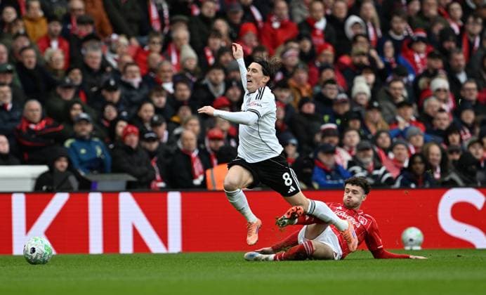 Harry Wilson of Fulham is tackled by Neco Williams of Nottingham Forest Nottingham Forest v Fulham, Premier League, Football, City Ground, Nottingham, UK - 15 Mar 2026Nottingham City Ground United Kingdom EDITORIAL USE ONLY No use with unauthorised audio, video, data, fixture lists, club league logos or live services. Online in-match use limited to 120 images, no video emulation. No use in betting, games or single club league player publications. Copyright: xAnnaxGowthorpe Shutterstockx 16757313am