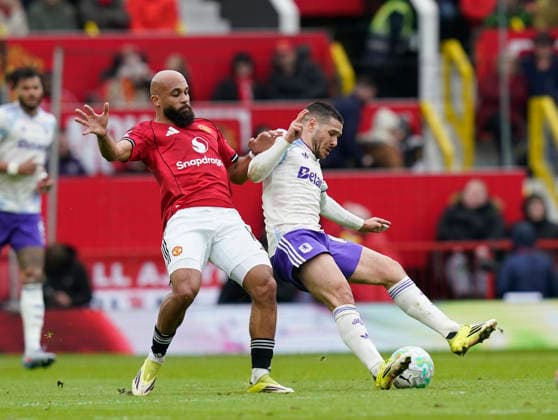 Manchester, England, 15th March 2026. Bryan Mbeumo of Manchester United, ManU (l) and Emiliano Buendia of Aston Villa (r) during the Manchester United vs Aston Villa Premier League match at Old Trafford, Manchester. Picture credit should read: Andrew Yates Sportimage EDITORIAL USE ONLY. No use with unauthorised audio, video, data, fixture lists, club league logos or live services. Online in-match use limited to 120 images, no video emulation. No use in betting, games or single club league player publications. SPI_027_AY_Man_Utd_Villa SPI-4605-0027