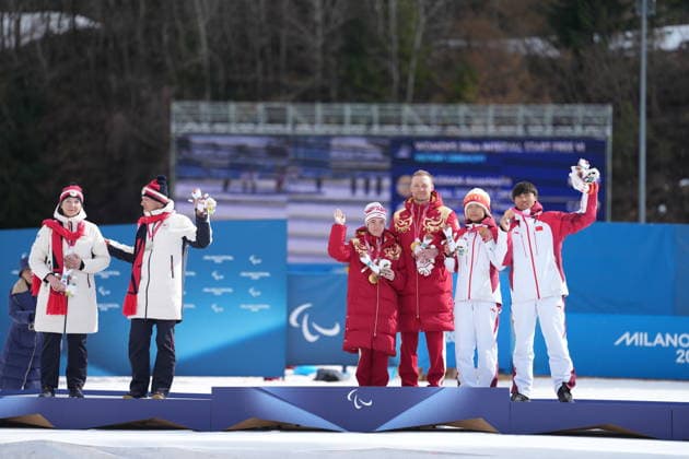 (260315) -- TESERO, March 15, 2026 -- Gold medalists Anastasiia Bagiian (3rd L) and her guide Sergei Siniakin (3rd R) of Russia, silver medalists Simona Bubenickova (1st L) and her guide David Srutek (2nd L) of the Czech Republic, bronze medalists Wang Yue (2nd R) and her guide Chen Guoming pose during the awarding ceremony for the para cross-country skiing women s 20km interval start free vision impaired at the Milan-Cortina 2026 Paralympic Winter games, Winterspiele,Spiele, Summer games in Tesero, Italy, March 15, 2026. ) (SP)ITALY-TESERO-PARALYMPIC WINTER GAMES-PARA CROSS-COUNTRY SKIING-WOMEN S 20KM INTERVAL START FREE VISION IMPAIRED HouxZhaokang 