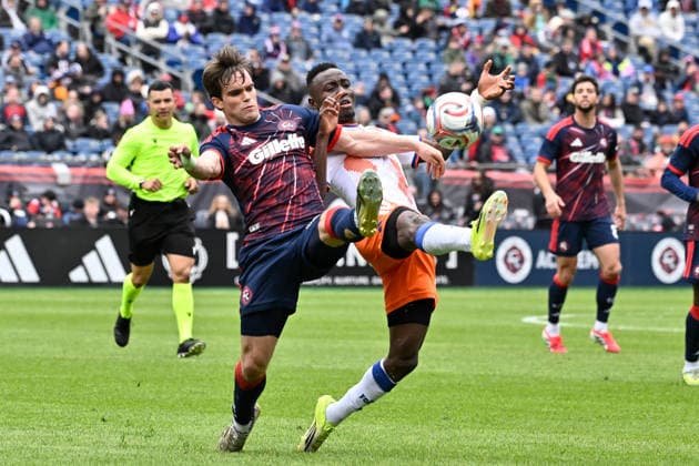 March 15, 2026; Foxborough, Massachusetts; New England Revolution defender Will Sands (23) and FC Cincinnati midfielder Obinna Nwobodo (5) battle for control of the ball during the first half at Gillette Stadium. CSM Foxborough USA - ZUMAc04_ 20260315_faf_c04_006 Copyright: xEricxCanhax
