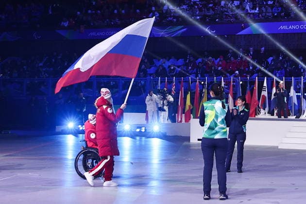 ITALY, CORTINA D AMPEZZO - MARCH 15, 2026: Para alpine skier Varvara Voronchikhina and para cross-country skier Ivan Golubkov of Russia parade during the closing ceremony of the 2026 Winter Paralympic Games at the Stadio Olimpico del Ghiaccio in Cortina d Ampezzo, Province of Belluno. Mikhail Tereshchenko TASS  90092408